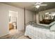 Bright primary bedroom showcases a lovely bed and a view to the en-suite bathroom at 11141 W Cameo Dr, Sun City, AZ 85351