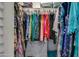 Spacious walk-in closet filled with an organized collection of colorful clothing at 11141 W Cameo Dr, Sun City, AZ 85351