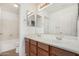 Bathroom vanity with double sinks and a mirror, plus a view to the tub and toilet at 11303 E Pratt Ave, Mesa, AZ 85212