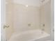 Corner bathtub with tiled walls and soap niche, plus fixtures at 11303 E Pratt Ave, Mesa, AZ 85212