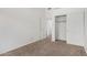 Spare bedroom featuring a closet and doorway to another room, carpeted floor at 11303 E Pratt Ave, Mesa, AZ 85212
