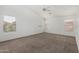 Large bedroom features neutral walls and carpet, large windows and plenty of open space at 11303 E Pratt Ave, Mesa, AZ 85212