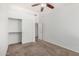 Spare bedroom with carpeted flooring, sliding closet doors, and a view to the bathroom at 11303 E Pratt Ave, Mesa, AZ 85212