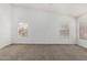 Well-lit bedroom with neutral carpet and paint and lots of natural light from large windows at 11303 E Pratt Ave, Mesa, AZ 85212