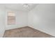 Bright bedroom features a standard window with neutral carpeting and a ceiling fan at 11303 E Pratt Ave, Mesa, AZ 85212