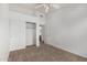 Spare bedroom with closet doors and doorway to the bathroom, carpeted flooring at 11303 E Pratt Ave, Mesa, AZ 85212