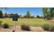 Community green space featuring mature landscaping and community signage, creating a welcoming environment for residents and guests at 11303 E Pratt Ave, Mesa, AZ 85212