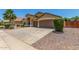 Spacious driveway leading to a charming home with well-maintained landscaping at 11303 E Pratt Ave, Mesa, AZ 85212