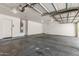 Spacious garage with ample room for parking, featuring a large garage door and a water heater at 11303 E Pratt Ave, Mesa, AZ 85212