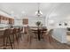 Eat-in kitchen features a center island, chandelier, bar seating, and tile floors at 11303 E Pratt Ave, Mesa, AZ 85212