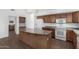 Bright kitchen features wood cabinets, white appliances, and a center island with neutral countertops at 11303 E Pratt Ave, Mesa, AZ 85212