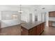 Kitchen with tile flooring, an island with barstool seating, and an open floor plan at 11303 E Pratt Ave, Mesa, AZ 85212