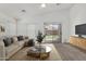 Cozy living room with a beige couch, coffee table, and a view of the backyard at 11303 E Pratt Ave, Mesa, AZ 85212