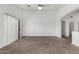 Spacious living room with sliding glass doors and a ceiling fan at 11303 E Pratt Ave, Mesa, AZ 85212