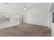 Spacious living room boasts neutral carpet, a ceiling fan and ample natural light from windows at 11303 E Pratt Ave, Mesa, AZ 85212