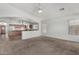 Open living area with views into the kitchen, carpet floors, and lots of natural light at 11303 E Pratt Ave, Mesa, AZ 85212