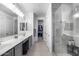 Bright bathroom with double sinks, walk in closet, and a frameless glass shower for a modern look at 13171 W Redstone Dr, Peoria, AZ 85383