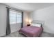 Cozy bedroom featuring a full sized bed, large window, and neutral carpeting at 13171 W Redstone Dr, Peoria, AZ 85383