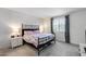 Bedroom featuring a wrought iron bed frame, neutral carpeting, and matching night stands at 13171 W Redstone Dr, Peoria, AZ 85383