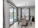 Bright dining area with modern light fixture and view of the inviting backyard pool at 13171 W Redstone Dr, Peoria, AZ 85383