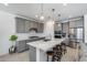 Well-lit kitchen features gray cabinets, stainless steel appliances, a large island, and bar stool seating at 13171 W Redstone Dr, Peoria, AZ 85383