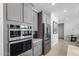 Kitchen features stainless steel appliances, gray cabinets, a built-in oven, and ample counter space at 13171 W Redstone Dr, Peoria, AZ 85383