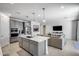 Open concept kitchen features a large island with bar seating, stainless appliances, and an airy living space at 13171 W Redstone Dr, Peoria, AZ 85383