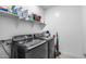 Convenient laundry room with modern washer and dryer units and ample shelving at 13171 W Redstone Dr, Peoria, AZ 85383