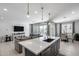 Open concept living space featuring kitchen island, comfortable seating, backyard access, and dining area at 13171 W Redstone Dr, Peoria, AZ 85383