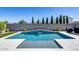 Inviting in-ground pool features a tranquil water feature, a modern design, and an expansive backyard at 13171 W Redstone Dr, Peoria, AZ 85383