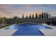 Backyard pool with waterfall feature and artificial grass, great for outdoor entertaining at 13171 W Redstone Dr, Peoria, AZ 85383