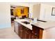 Kitchen island and sink with view into adjacent living space at 133 W Balboa Dr, Tempe, AZ 85282