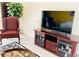 Comfortable wingback chair and TV on wooden media console in living room at 133 W Balboa Dr, Tempe, AZ 85282