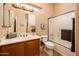 Bright bathroom features a spacious vanity, large mirror, and a shower over the bath at 13444 W Cabrillo Dr, Sun City West, AZ 85375