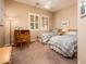 Cozy bedroom features twin beds, neutral carpet, plantation shutters, and a view to the outdoors at 13444 W Cabrillo Dr, Sun City West, AZ 85375