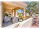Comfortable covered patio with relaxing seating area overlooking beautiful landscaping at 13444 W Cabrillo Dr, Sun City West, AZ 85375