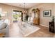 Elegant dining area featuring a glass table, stylish chairs, and access to the outdoor patio at 13444 W Cabrillo Dr, Sun City West, AZ 85375