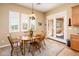 Cozy dining area with wood table, shutters on windows, and direct access to outdoor patio area at 13444 W Cabrillo Dr, Sun City West, AZ 85375