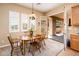 Cozy dining area with wood table, shutters on windows, and direct access to outdoor patio area at 13444 W Cabrillo Dr, Sun City West, AZ 85375
