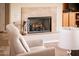 Cozy fireplace with tile surround, complemented by a comfortable chair and built-in cabinet at 13444 W Cabrillo Dr, Sun City West, AZ 85375