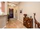 Charming foyer featuring a decorative cabinet, eye-catching giraffe art and lovely flooring at 13444 W Cabrillo Dr, Sun City West, AZ 85375