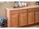 Wooden kitchen cabinets with light countertops and decorative elements on top at 13444 W Cabrillo Dr, Sun City West, AZ 85375