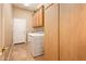 Convenient laundry room with washer, dryer, and ample storage cabinets at 13444 W Cabrillo Dr, Sun City West, AZ 85375