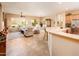 Bright, open-concept living space with comfortable seating and stylish tile flooring at 13444 W Cabrillo Dr, Sun City West, AZ 85375