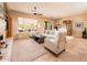 Inviting living room featuring neutral tones, comfortable seating, and large windows offering ample natural light at 13444 W Cabrillo Dr, Sun City West, AZ 85375
