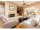 Cozy living room with a fireplace, built-in shelving, and comfortable seating perfect for relaxation at 13444 W Cabrillo Dr, Sun City West, AZ 85375