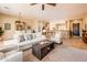 Open-concept living room with dining area featuring comfortable seating, stylish decor, and abundant natural light at 13444 W Cabrillo Dr, Sun City West, AZ 85375