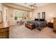 Spacious main bedroom offers abundant natural light, tray ceiling, and an oversized decorative window at 13444 W Cabrillo Dr, Sun City West, AZ 85375