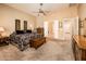 Spacious main bedroom with neutral carpet, decorative furnishings, and easy access to the main bathroom at 13444 W Cabrillo Dr, Sun City West, AZ 85375