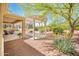 Inviting outdoor patio with pergola, desert landscaping, and ample seating space at 13444 W Cabrillo Dr, Sun City West, AZ 85375